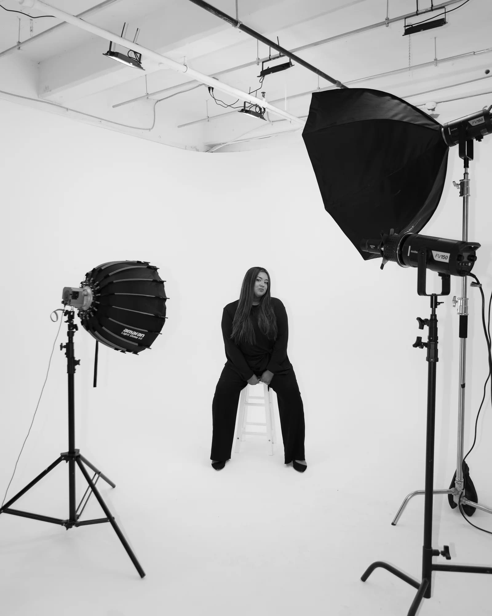 Sana Raza in professional photography studio with lighting equipment