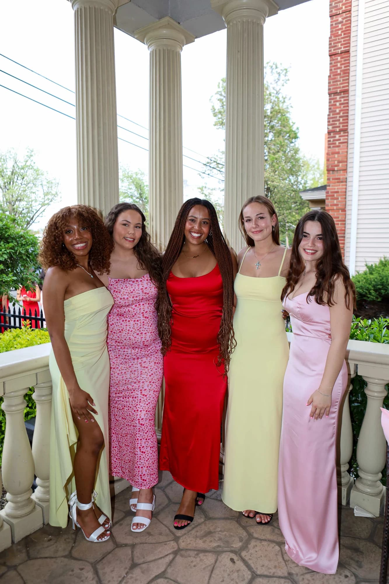 Group of women in colorful formal dresses