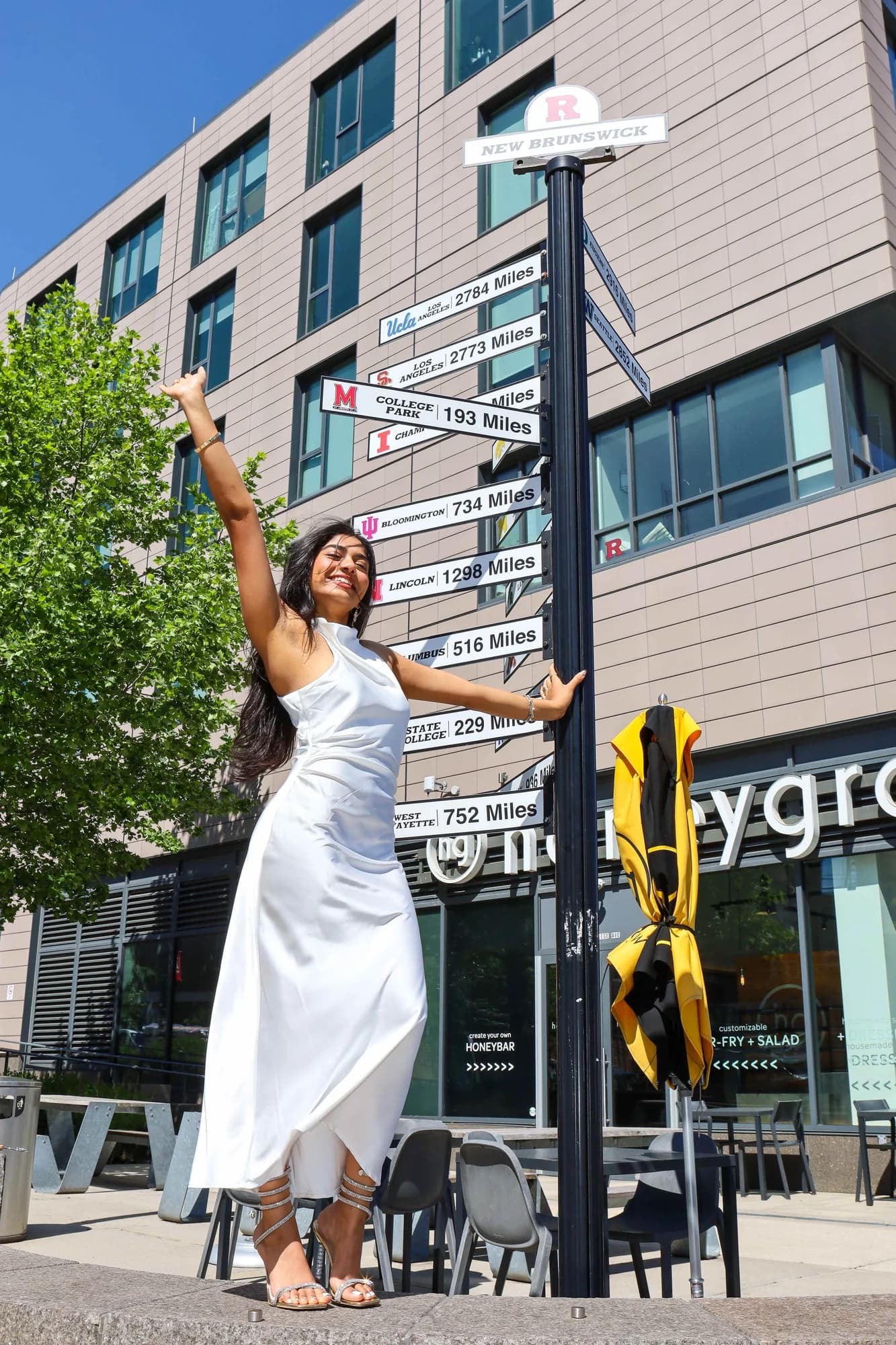 Graduate portrait at Rutgers direction sign