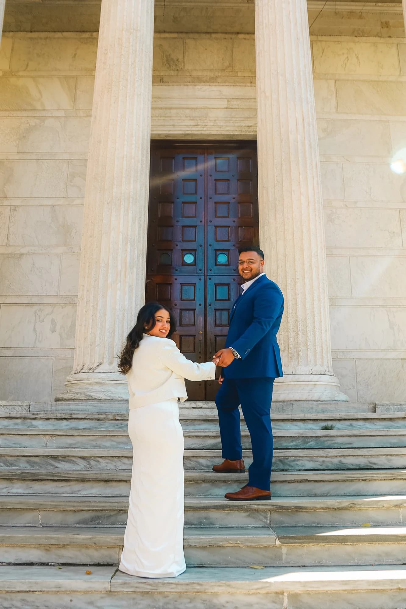Couples portrait on marble steps with columns