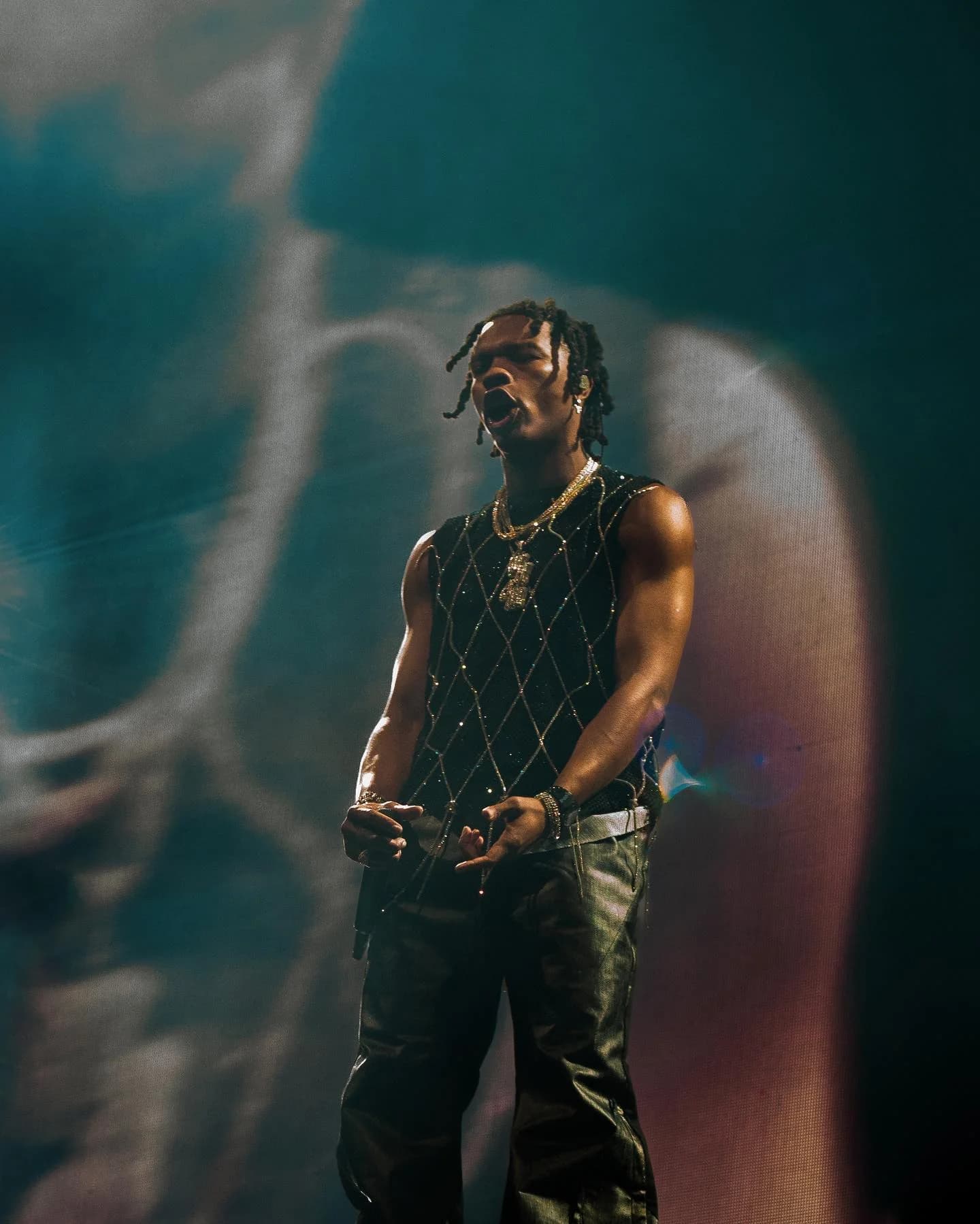 Concert performer in teal stage lighting