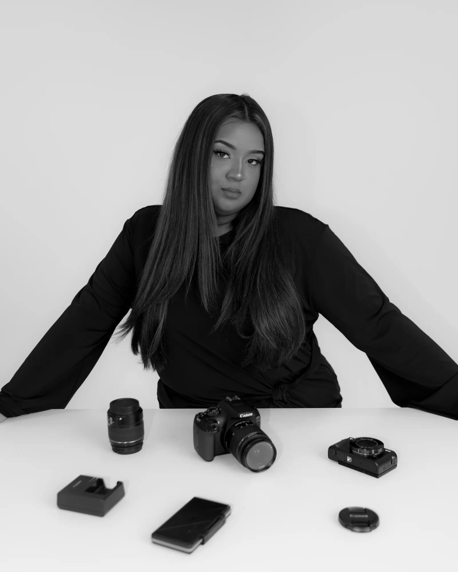 Sana Raza - B&W studio portrait with camera gear on table